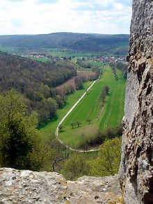 Blick über das Werntal: Ruhige Wege und bewaldete Hügel am Horizont sind typisch für die Region in Franken.