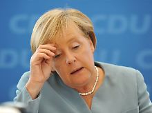 Abwarten: Kanzlerin Merkel will sich noch nicht festlegen.