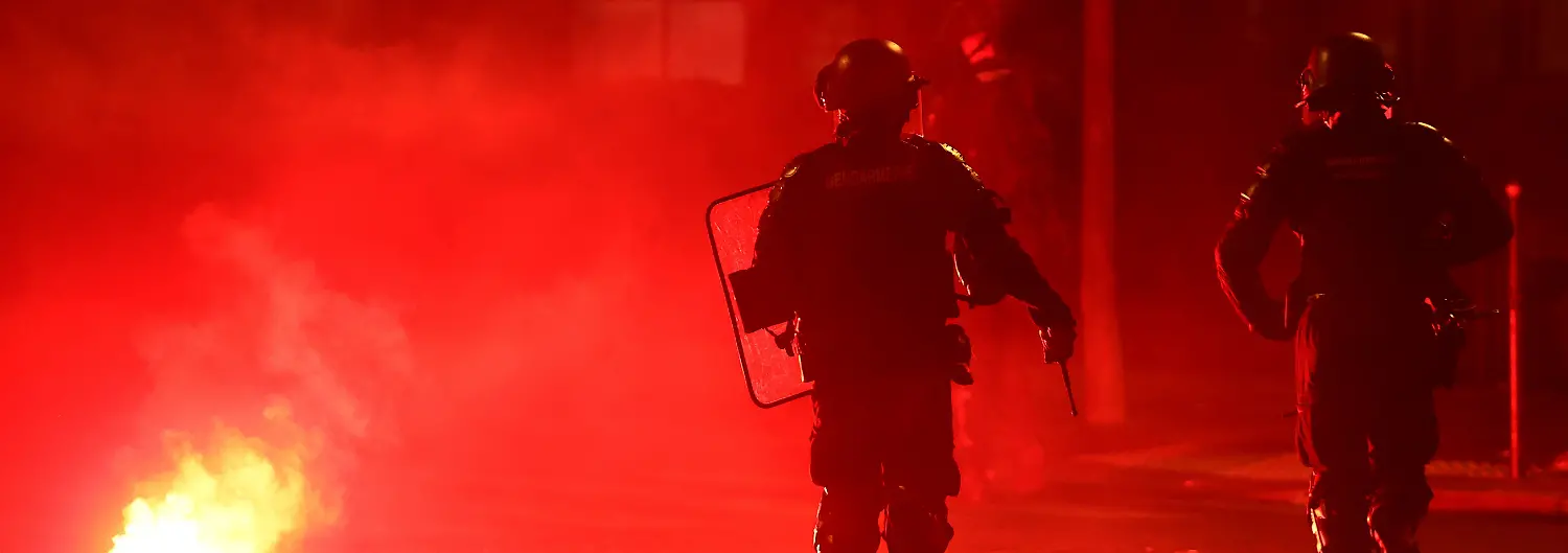 Soccer-Football-UEFA-Champions-League-Paris-St-Germain-fans-celebrate-winning-the-UEFA-Champions-League-Paris-France-May-31-2026-Police-officers-protect-themselves-from-a-flare-after-Paris-St-Germain-won-the-UEFA-Champions-League-REUTERS-Abdul-Saboor
