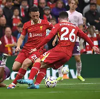Liverpool-s-Andrew-Robertson-right-Liverpool-s-Diogo-Jota-centre-challenges-for-the-ball-with-Brentford-s-Bryan-Mbeumo-during-the-English-Premier-League-soccer-match-between-Liverpool-and-Brentford-at-Anfield-Stadium-Liverpool-England-Sunday-Aug-25-2024