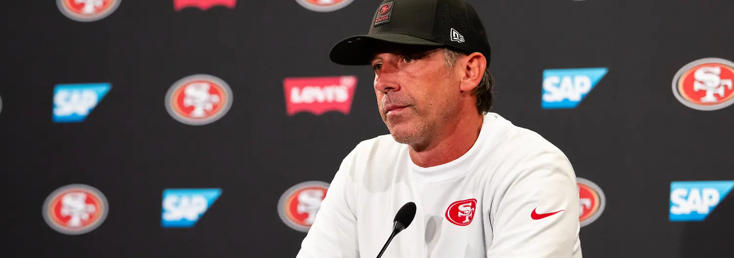 SANTA-CLARA-CA-AUGUST-04-San-Francisco-49ers-Head-Coach-Kyle-Shanahan-speaks-to-the-media-during-San-Francisco-49ers-Training-Camp-on-August-4-2025-at-the-SAP-Performance-Facility-in-Santa-Clara-CA