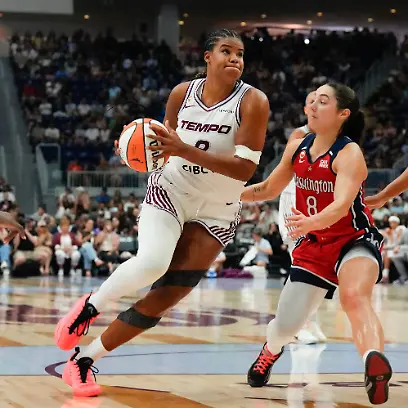 Toronto-Tempo-s-Nyara-Sabally-left-drives-at-Washington-Mystics-Georgia-Amoore-8-and-Shakira-Austin-0-during-the-first-half-of-a-WNBA-basketball-game-in-Toronto-Tuesday-July-14-2026