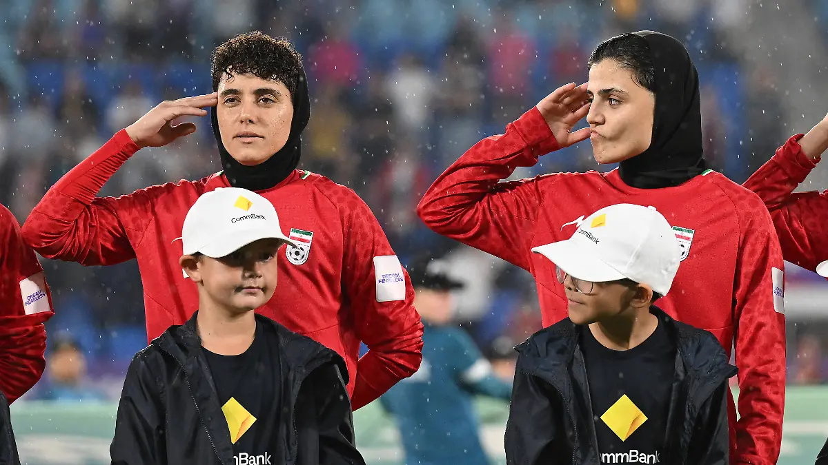 SOCCER-ASIAN-CUP-IRAN-PHILIPPINES-Iran-player-Fatemeh-Pasandideh-right-reacts-during-the-national-anthem-of-Iran-prior-to-the-AFC-Womens-Asian-Cup-Group-A-match-between-Iran-and-Philippines-at-Gold-Coast-Stadium-on-the-Gold-Coast-Sunday-March-8-2026-Pasandideh-is-one-of-seven-Iranian-players-who-have-stayed-on-in-Australia-after-being-granted-humanitarian-visas