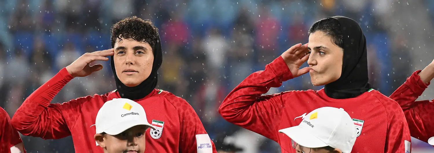 SOCCER-ASIAN-CUP-IRAN-PHILIPPINES-Iran-player-Fatemeh-Pasandideh-right-reacts-during-the-national-anthem-of-Iran-prior-to-the-AFC-Womens-Asian-Cup-Group-A-match-between-Iran-and-Philippines-at-Gold-Coast-Stadium-on-the-Gold-Coast-Sunday-March-8-2026-Pasandideh-is-one-of-seven-Iranian-players-who-have-stayed-on-in-Australia-after-being-granted-humanitarian-visas