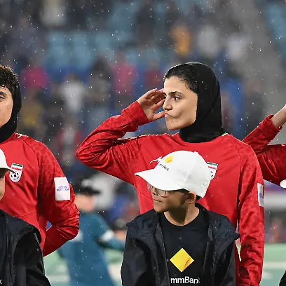 SOCCER-ASIAN-CUP-IRAN-PHILIPPINES-Iran-player-Fatemeh-Pasandideh-right-reacts-during-the-national-anthem-of-Iran-prior-to-the-AFC-Womens-Asian-Cup-Group-A-match-between-Iran-and-Philippines-at-Gold-Coast-Stadium-on-the-Gold-Coast-Sunday-March-8-2026-Pasandideh-is-one-of-seven-Iranian-players-who-have-stayed-on-in-Australia-after-being-granted-humanitarian-visas