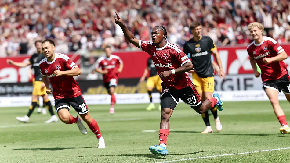 09-08-2026-Bayern-Nuernberg-Fussball-Maenner-2-Bundesliga-1-FC-Nuernberg-Dynamo-Dresden-1-Spieltag-Max-Morlock-Stadion-Mohamed-Ali-Zoma-1-FC-Nuernberg-M-jubelt-mit-Julian-Justvan-1-FC-Nuernberg-l-und-Piet-Scobel-1-FC-Nuernberg-nach-seinem-Tor-zum-1-0-Foto-Daniel-Loeb-dpa-WICHTIGER-HINWEIS-Gemaess-den-Vorgaben-der-Bundesliga-bzw-des-DFB-Deutscher-Fussball-Bund-ist-es-untersagt-in-dem-Stadion-und-oder-vom-Spiel-angefertigte-Fotoaufnahmen-in-Form-von-Sequenzbildern-und-oder-videoaehnlichen-Fotostrecken-zu-verwerten-bzw-verwerten-zu-lassen