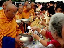 Buddhistische Mönche in Bangkok empfangen ihre Morgengaben.