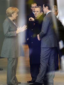 Merkel im Gespräch mit den Verteidigungsministern Ehud Barak und Karl-Theodor zu Guttenberg.