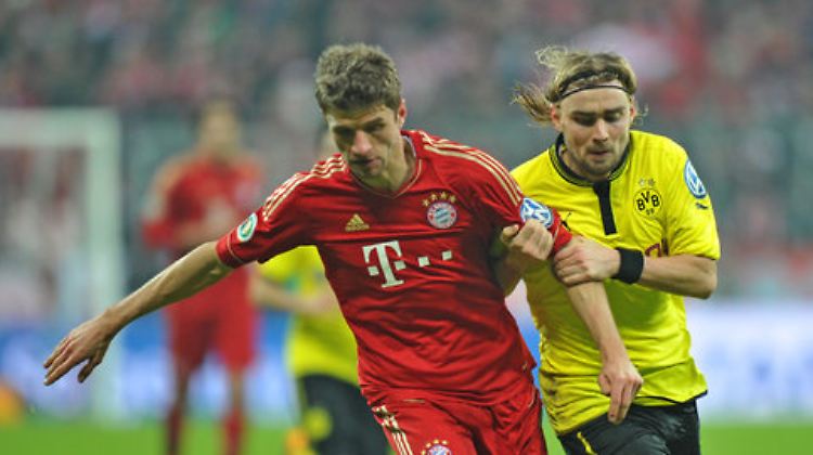 Der Münchner Thomas Müller und  Marcel Schmelzer aus Dortmund im Kampf um den Ball.