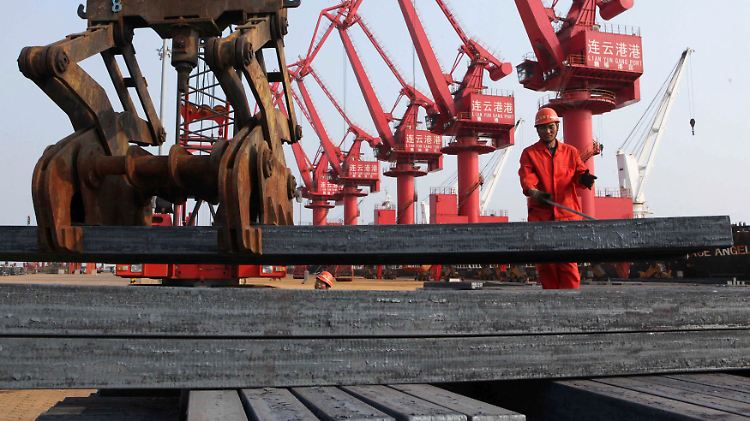 Arbeiter löschen eine Ladung Stahlbarren in einem Hafen in Lianyungang.