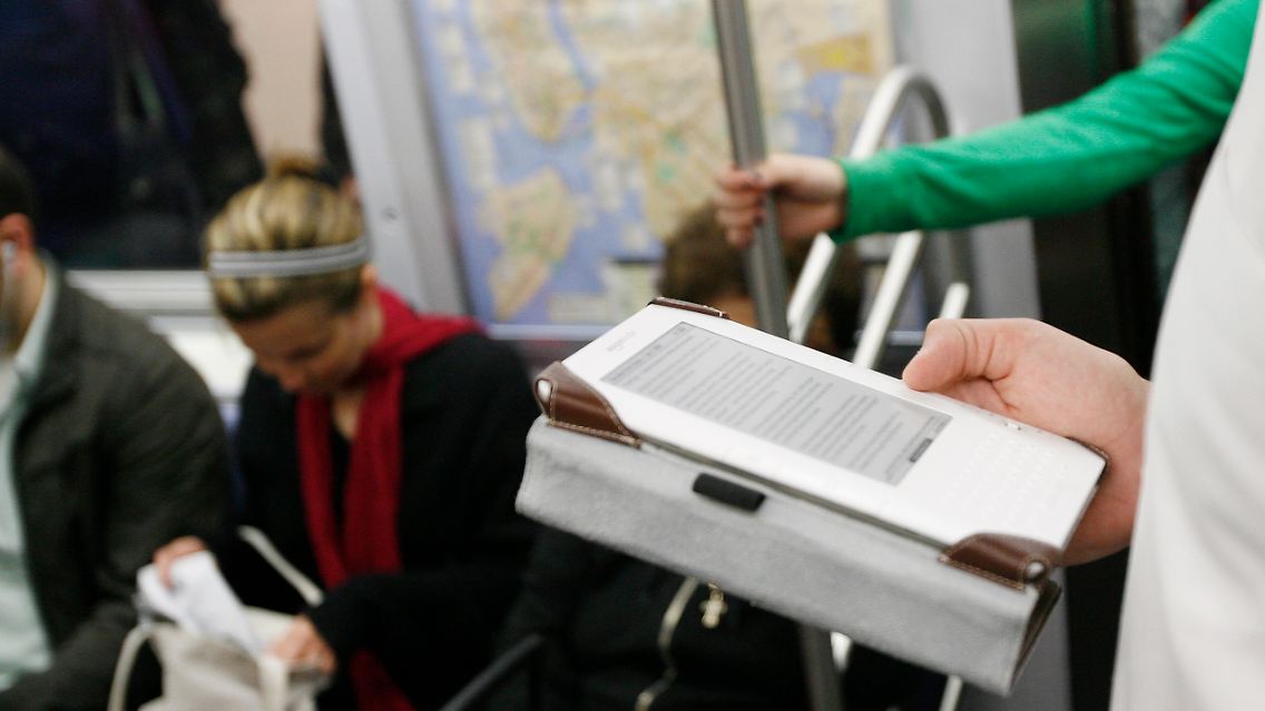 Ein Pendler nutzt in der New Yorker U-Bahn einen Kindle.