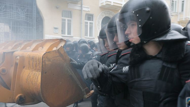 In Kiew versuchen Demonstranten, eine Absperrung der Polizei zu durchbrechen.