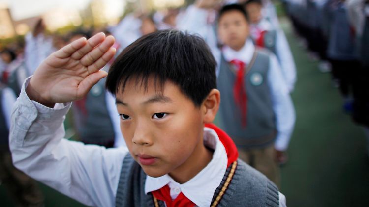 An einer Schule in Shanghai zeigt ein Schüler den Pioniergruß.