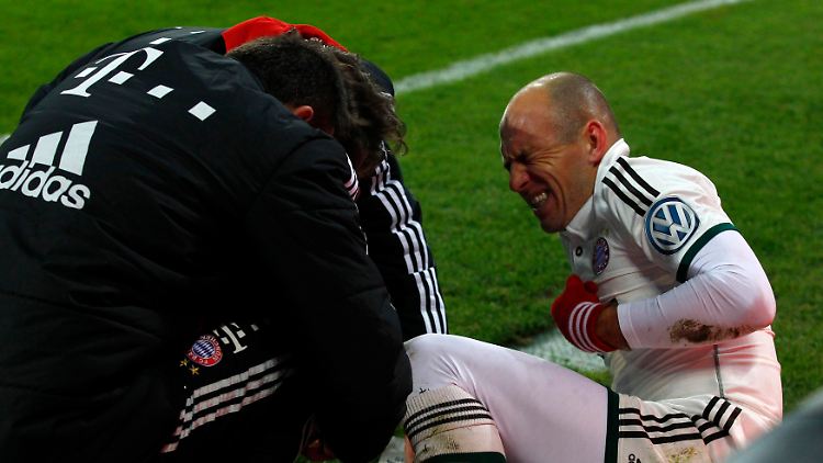 Das tut weh: Arjen Robben windet sich nach dem Zusammenstoß mit FCA-Keeper Marwin Hitz vor Schmerz.