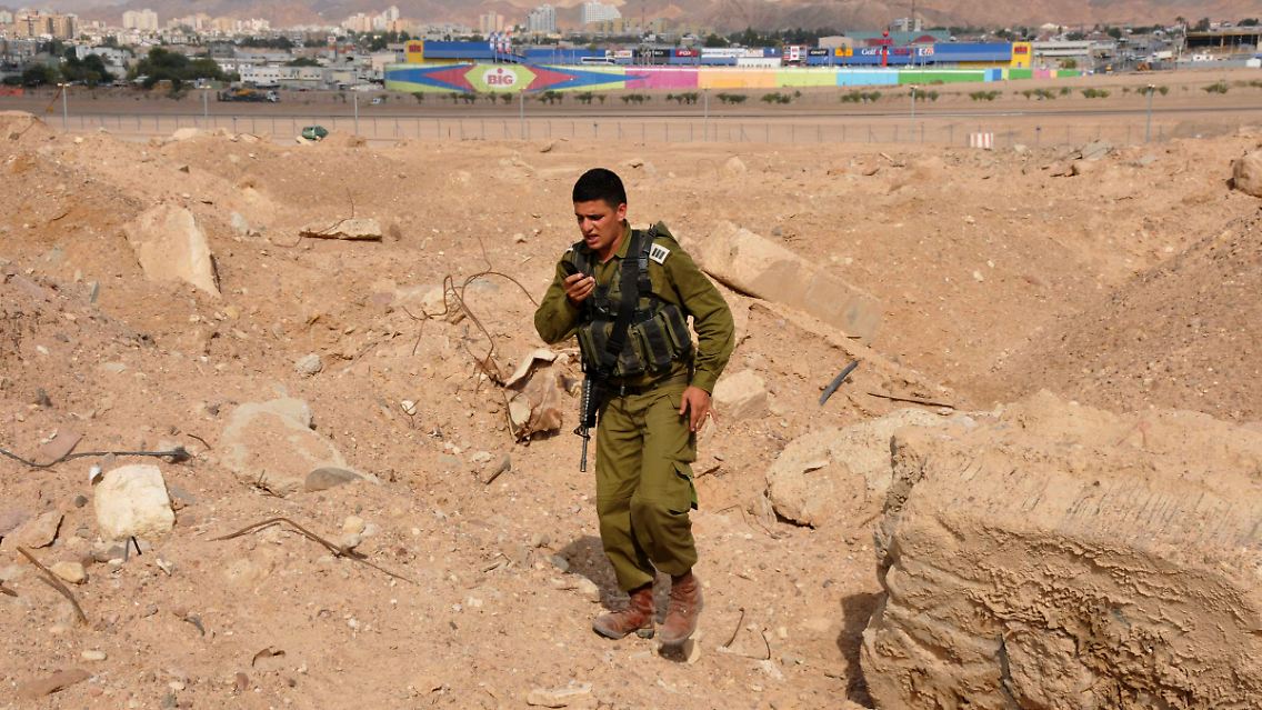 Ein israelischer Soldat sucht in Eilat nach Raketen-Resten.
