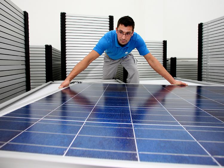 Bloß keine Kratzer: Ein Conergy-Mitarbeiter stapelt Solarmodule übereinander.