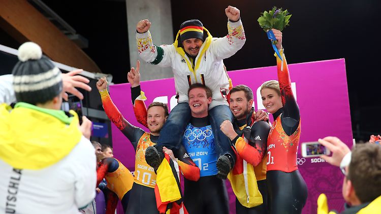 So sehen Sieger aus: Die "Trainingsgruppe Sonnenschein" feiert Team-Gold in Sotschi.