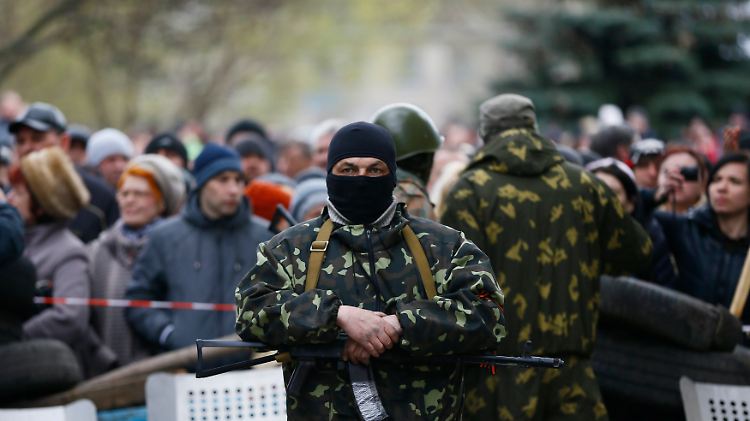 Ein bewaffneter Mann steht an einer Barrikade vor de Polizeiwache in Slawjansk.