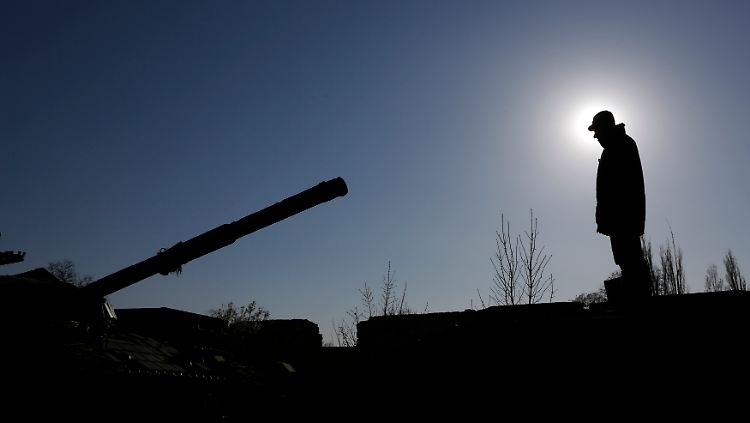 Ein russischer Soldat verlädt einen russischen Panzer auf einem Bahnhof auf der Krim.