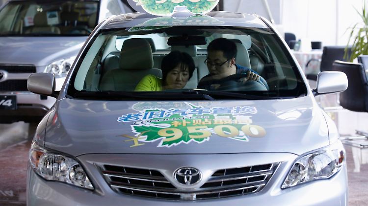 Mängel unterm Armaturenbrett: Ein Paar begutachtet bei einem Händler in Peking die Ausstattung eines Toyota Corolla (Archivbild).