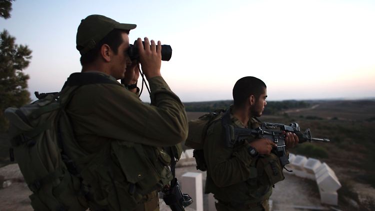 Israelische Soldaten schauen nach Gaza. Die Armee will zwar keine neuen Luftangriffe fliegen, zieht ihre Panzer aber nicht ab.