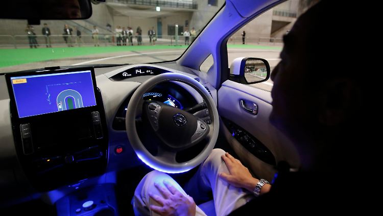Ein Nissan-Mitarbeiter hinter dem Steuer eines autonom fahrenden Autos.