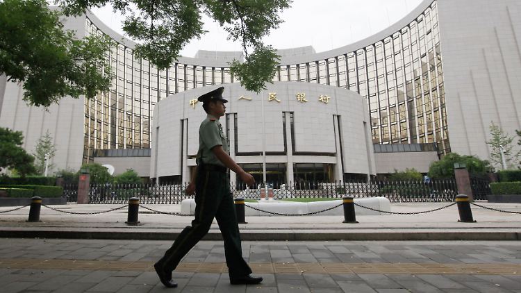 Präzise gestutzte Hecken: Ein Wachmann patrouilliert vor der chinesischen Zentralbank in Peking.