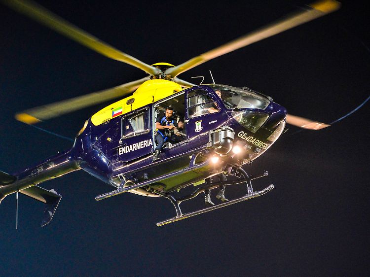 In den offenen Türen halten sich Einsatzkräfte bereit, Tränengasgranaten in die aufgebrachte Menge zu feuern.