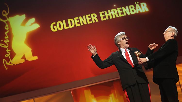Wim Wenders (l.) ist begeistert, als ihm Berlinale-Direktor Dieter Kosslick den Goldenen Ehrenbären überreicht.