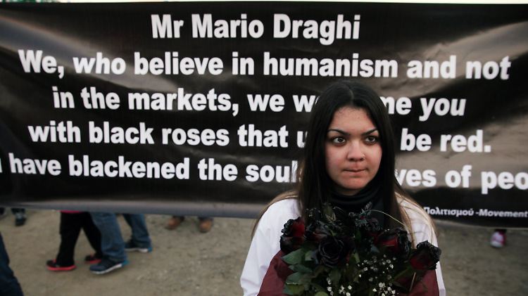Ein Mädchen demonstriert mit schwarzen Blumen gegen die Sparpolitik der EZB in Nikosia. Im Hintergrund ein Brief an EZB-Chef Draghi.