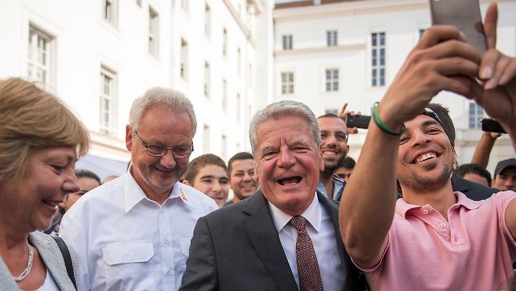 Gauck mit ASB-Leiter Detlef Kühn, Lebensgefährtin Daniela Schadt und einem syrischen Flüchtling. Der Bundespräsident lobt in Berlin-Wilmersdorf freiwilliges Engagement und warnt Flüchtlinge vor einer Anspruchshaltung.