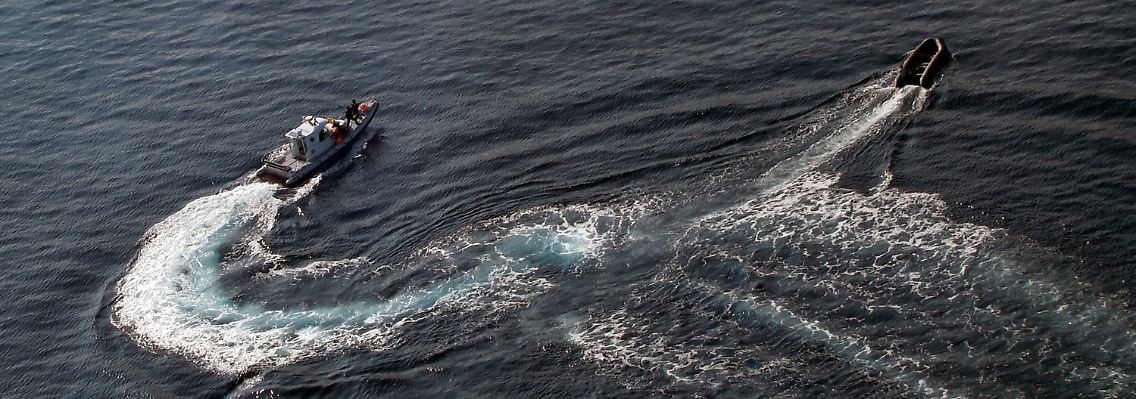 Ein Schiff der griechischen Küstenwache verfolgt ein verdächtiges Boot.