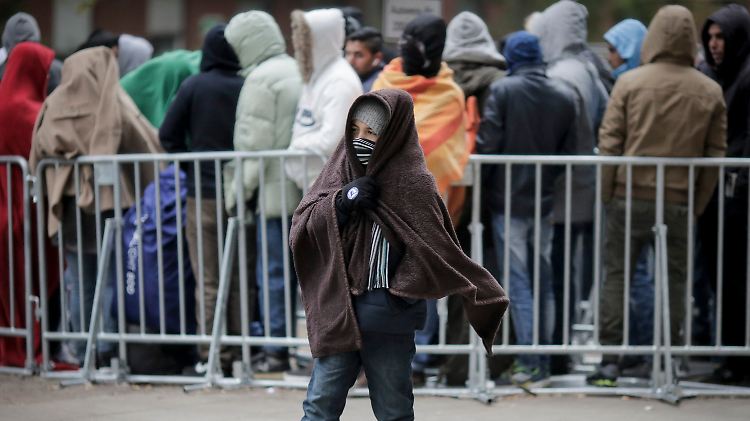 Bei kühlem Wetter warten Flüchtlinge auf ihre Registrierung und die Zuweisung eines Schlafplatzes.