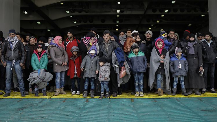 Flüchtlinge kommen an Bord einer Fähre im Hafen von Piräus an. 
