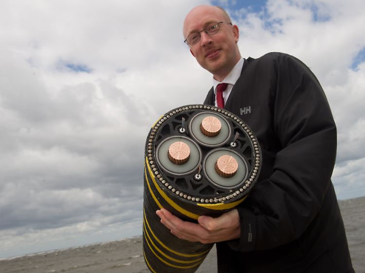 Strom aus der Ostsee: Landesverkehrsminister Christian Pegel mit einem der Seekabel, mit dem Netzbetreiber die Windräder ans Stromnetz anschließen wollen.
