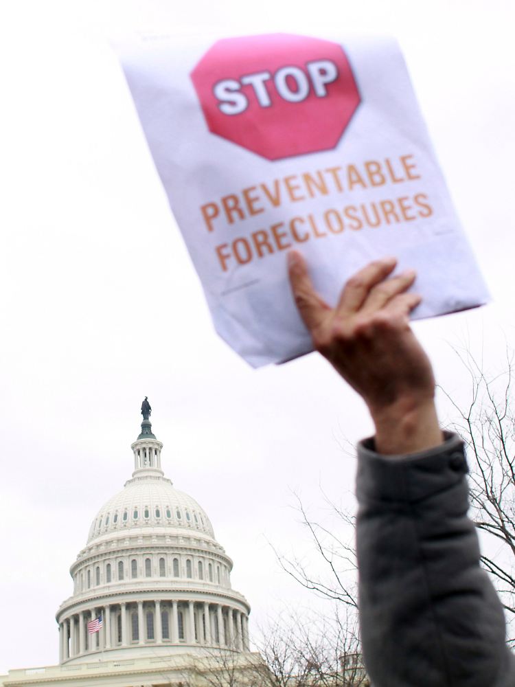 Es gärt in der Bevölkerung: "Vermeidbare Zwangsversteigerungen stoppen", fordert dieser US-Bürger in Washington.