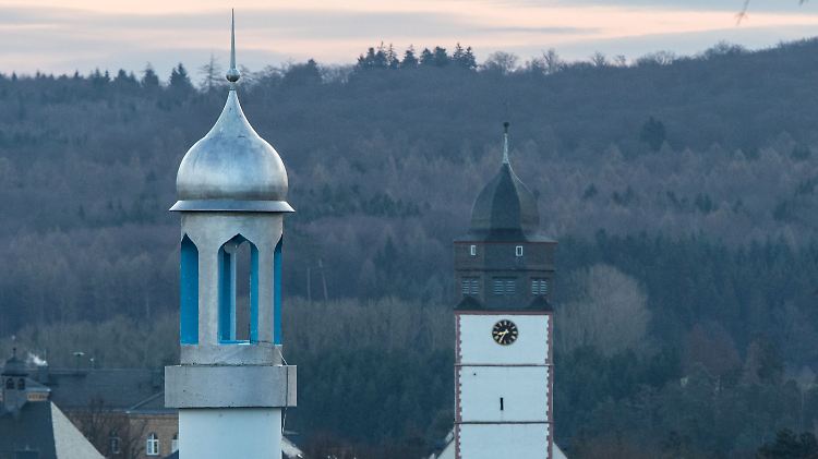 Das Minarett (l.) einer Moschee und die Laurentiuskirche in Usingen im Taunus.
