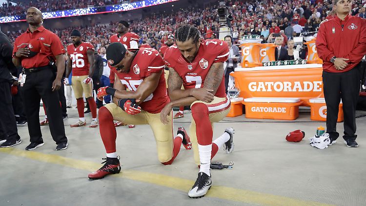 Quarterback Kaepernick (r.) wird von seinem Teamkollegen Eric Reid unterstützt.