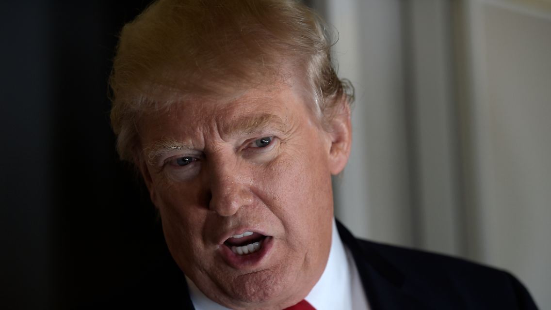 President Donald Trump speaks to reporters on Air Force One while traveling to Palm Beach International Airport in West Palm Beach, Fla., Friday, Feb. 3, 2017. Trump is spending the weekend at Mar-a-Lago. (AP Photo/Susan Walsh)