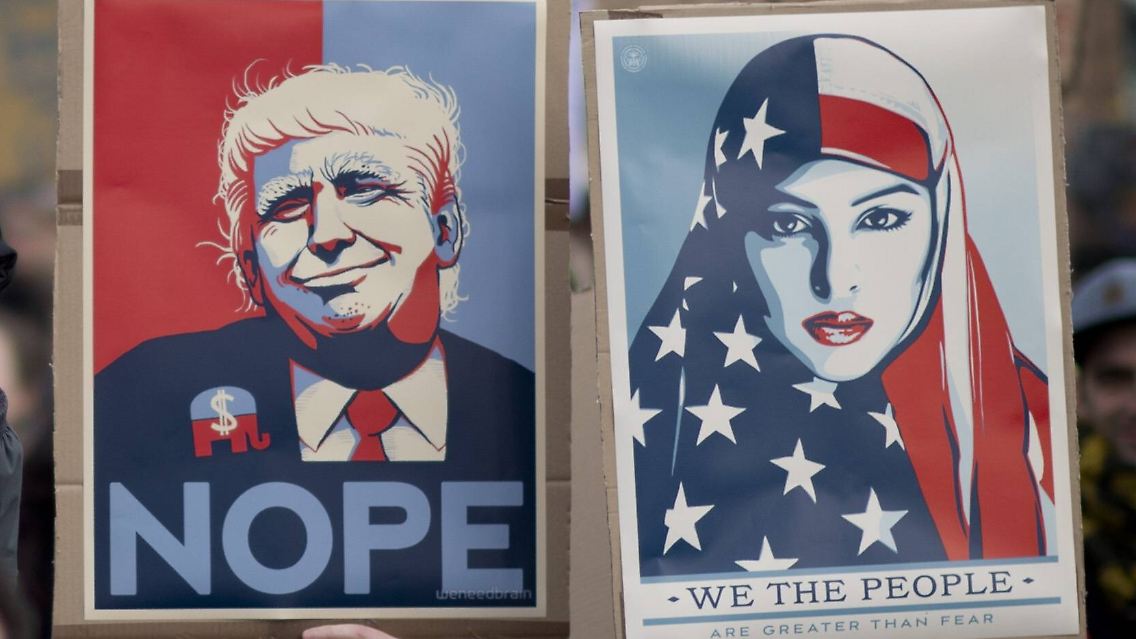 Protest against Trump DEU, Deutschland, Germany, Berlin, 04.02.2017 Demonstranten mit Plakat Nope and We the People und Motiv muslimische Frau vom Designer Shepard Fairey auf der Demonstration von Deutschen und Amerikanerin unter dem Motto No Ban No Wall, Sofortiges Ende des Einreiseverbots gegen die Politik von Donald Trump als Praesident der USA vor dem Brandenburger Tor in Berlin. Die Kundgebung richtet sich gegen das Dekret zum Einreiseverbot von Muslimen aus sieben Laendern, gegen den Bau der Mauer zu Mexiko wie auch gegen Fremdenfreindlichkeit, Sexismus, Frauenfeindlichkeit, Rassismus, Islamphobie welche mit Trump verbunden werden. Protester with sign Nope and We the People and motive of a muslim woman We the People by Designer Shepard Fairey attend a protest rally under the slogan No Ban No Wall, End the ban Now, Refuges and Immigrants are welcome, against the new U.S. President Protest against Trump DEU Germany Germany Berlin 04 02 2017 Demonstrators with Billboard NOPE and We The Celebrities and Motif Muslim Woman of Designers Shepard Fairey on the Demonstration from German and American woman under the Motto No Ban No Wall immediate End the against the politics from Donald Trump as President the USA before the Brandenburg goal in Berlin the Rally directed to against the Decree to Entry ban from Muslims out Seven Countries against the Construction the Wall to Mexico like too against Sexism Misogyny Racism Islamphobie which with Trump connected will protester With Sign NOPE and We The Celebrities and Motives of a Muslim Woman We The Celebrities by Designers Shepard Fairey attend a Protest Rally Under The Slogan No Ban No Wall End The Ban Now refuges and Immigrants are Welcome against The New U S President