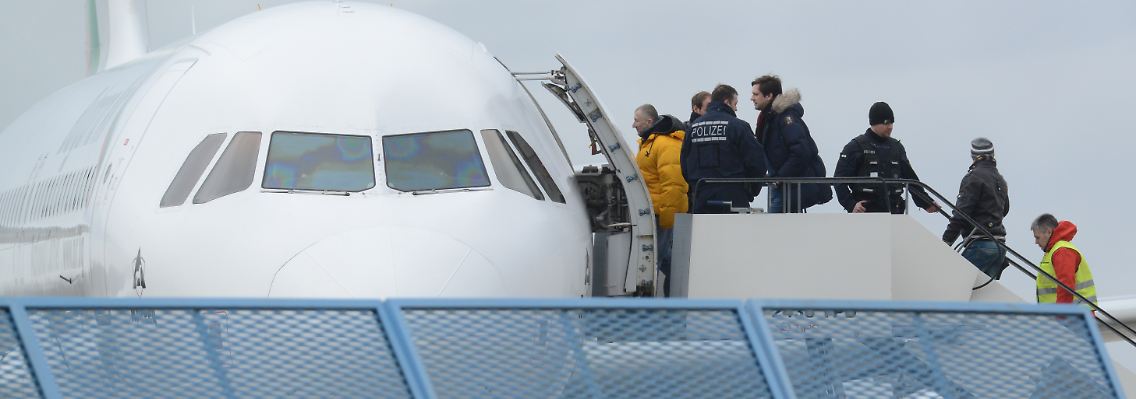 Abgelehnte Asylbewerber steigen in eine Maschine.