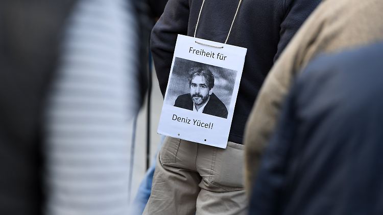 Bei einer Mahnwache fordern Menschen die Freilassung von Deniz Yücel.