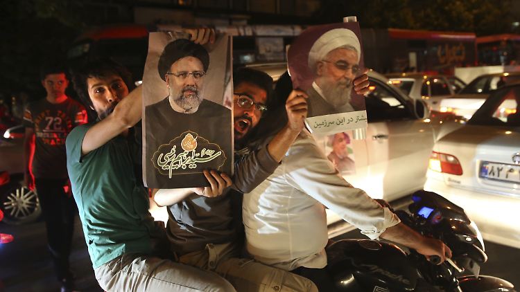 Vor der Präsidentenwahl im Iran werben Anhänger von Ruhani und Raisi für ihre Kandidaten.
