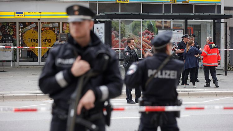 Polizisten sichern schwerbewaffnet den Tatort in der Fuhlsbütteler Straße.