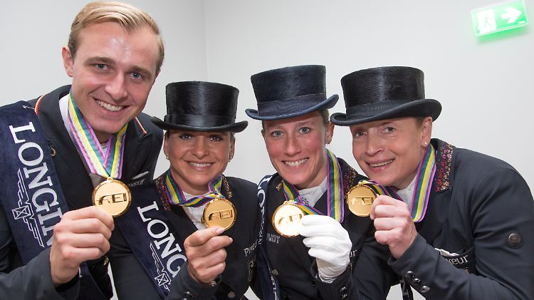 Die deutschen Dressurreiter Sönke Rothenberger (l-r), Dorothee Schneider, Helen Langehanenberg und Isabell Werth präsentieren ihre Goldmedaillen.