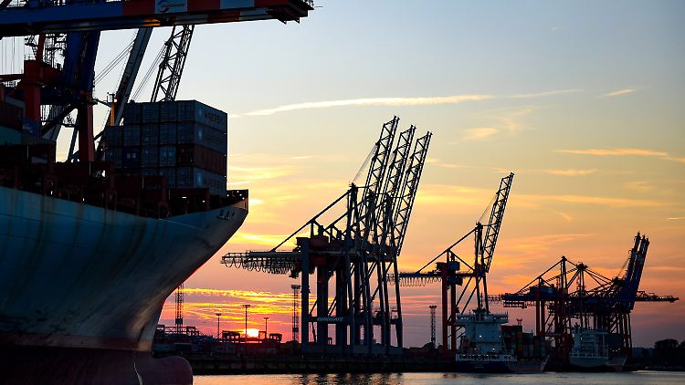 Sonnenuntergang im Hamburger Hafen hinter Kränen zur Containerverladung.