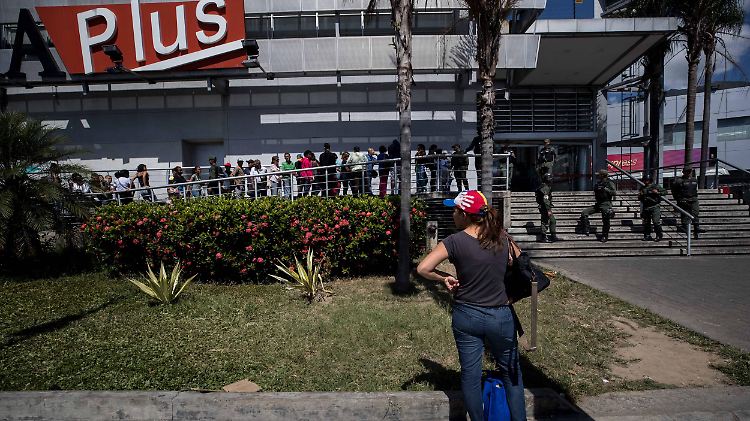Schlangestehen vor einem Supermarkt in Caracas. Das Militär soll weitere Plünderungen verhindern.