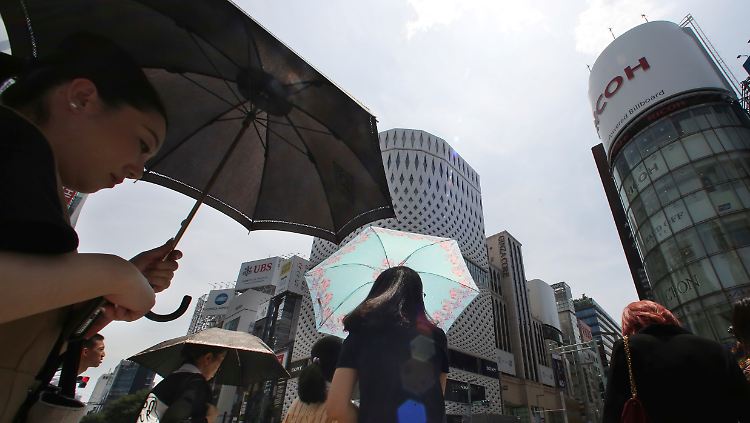Hitzewelle in Japan: Mit Schirmen versuchen sich Passanten im Ginza-Distrikt vor den Strahlen der Sommersonne zu schützen.