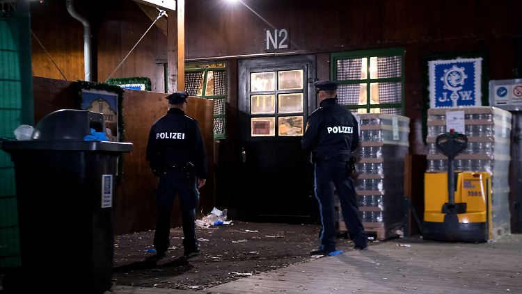 Zwei Polizisten sichern am Festzelt den Tatort ab.