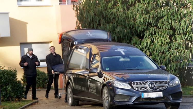 Mitarbeiter eines Bestattungsunternehmens transportieren eine Leiche aus der Familienwohnung in Böblingen.